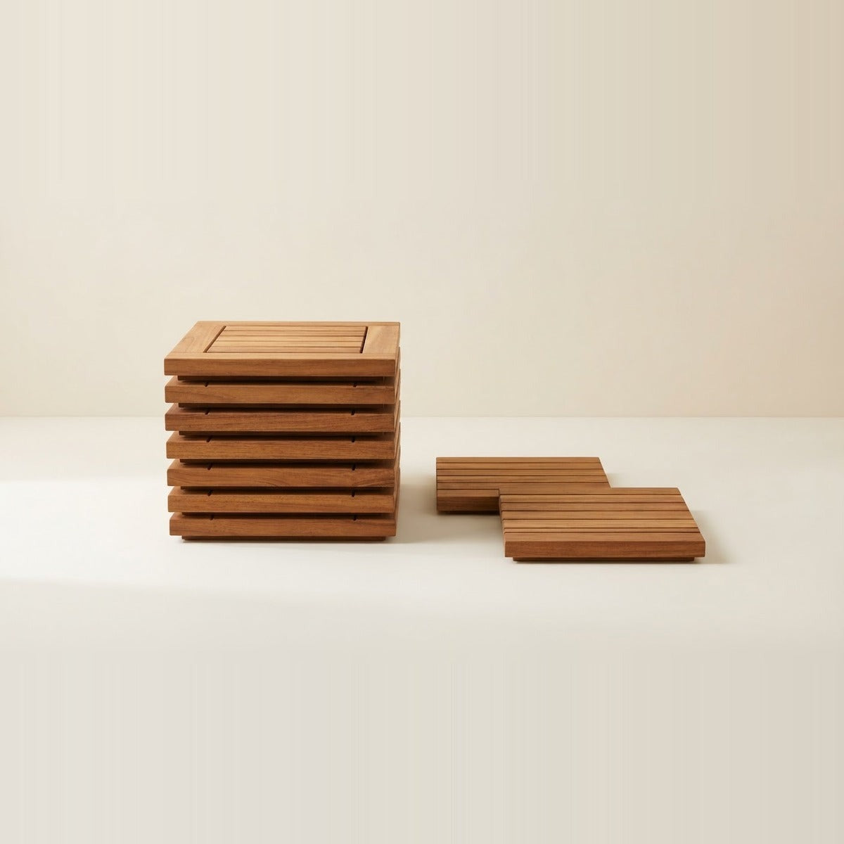 Decking Tiles — a stack of wooden decking tiles with two single tiles set beside it on a cream floor