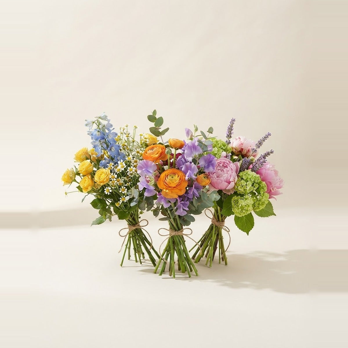 Birthday Flowers — three cheerful mixed flower bunches loosely tied