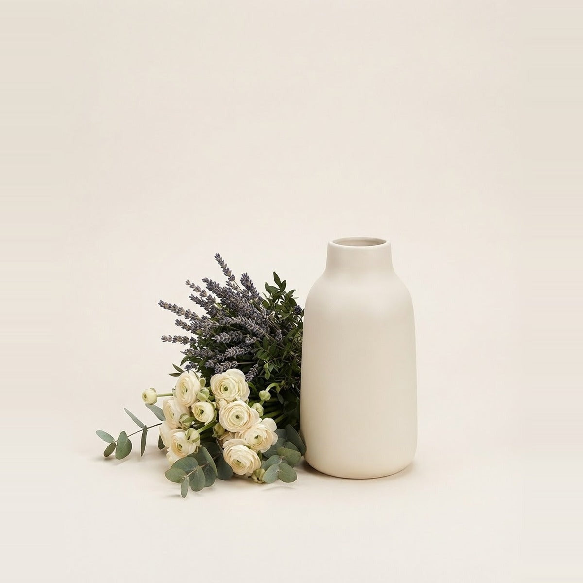 Flowers for Home Décor — two flower bunches beside a simple cream ceramic vase