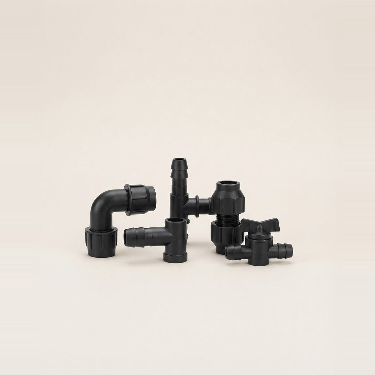 Fittings & Connectors — a small group of black irrigation fittings and connectors laid out together