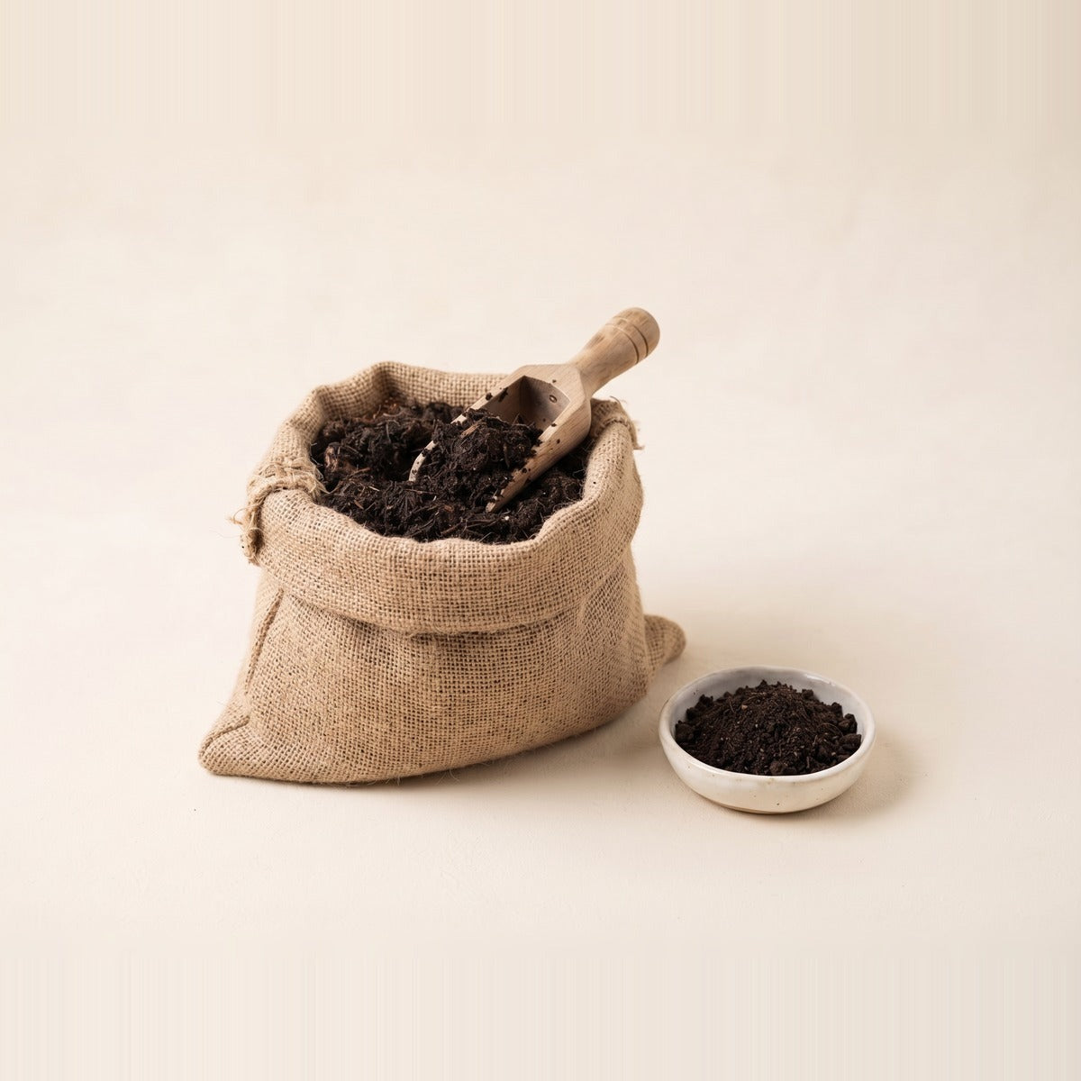 Organic Fertilizers & Compost — organic compost and fertiliser - a mound of dark crumbly compost, a scoop of pellets and a handful of worm castings in shallow terracotta dishes
