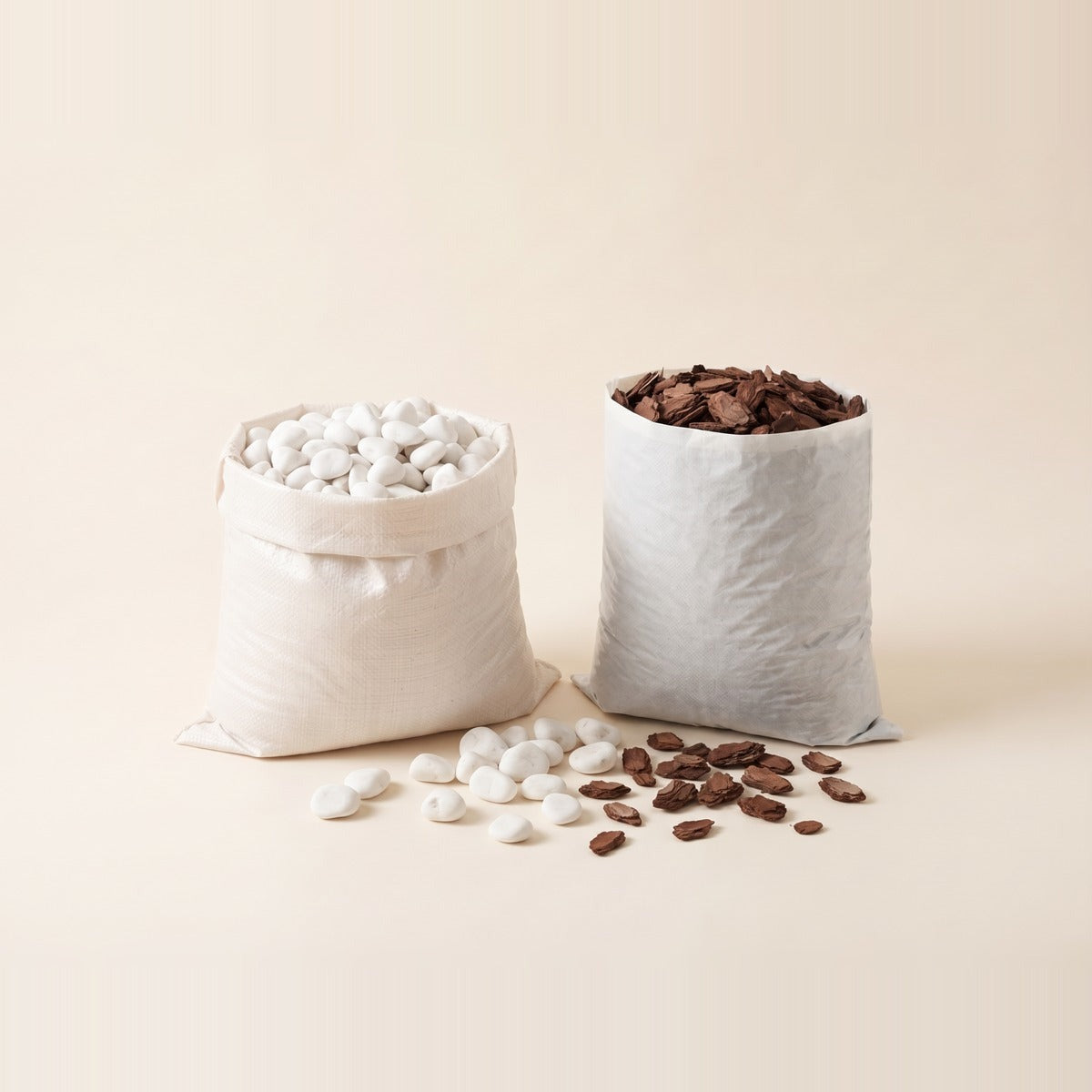 Rocks, Pebbles & Mulch — decorative garden rocks, white pebbles, river stones and dark bark mulch in four separate low terracotta dishes