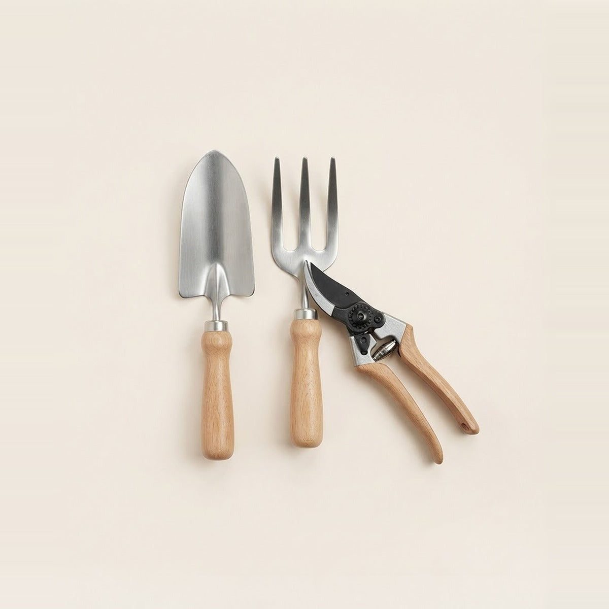 Tools — customer favorites — three garden hand tools - a trowel, a hand fork and pruning shears - laid together