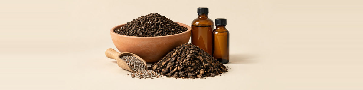 Soil & Nutrition — potting soil and plant nutrition together - a wide terracotta bowl of dark soil, a mound of compost, a scoop of granular fertiliser and two unlabelled amber bottles of liquid feed