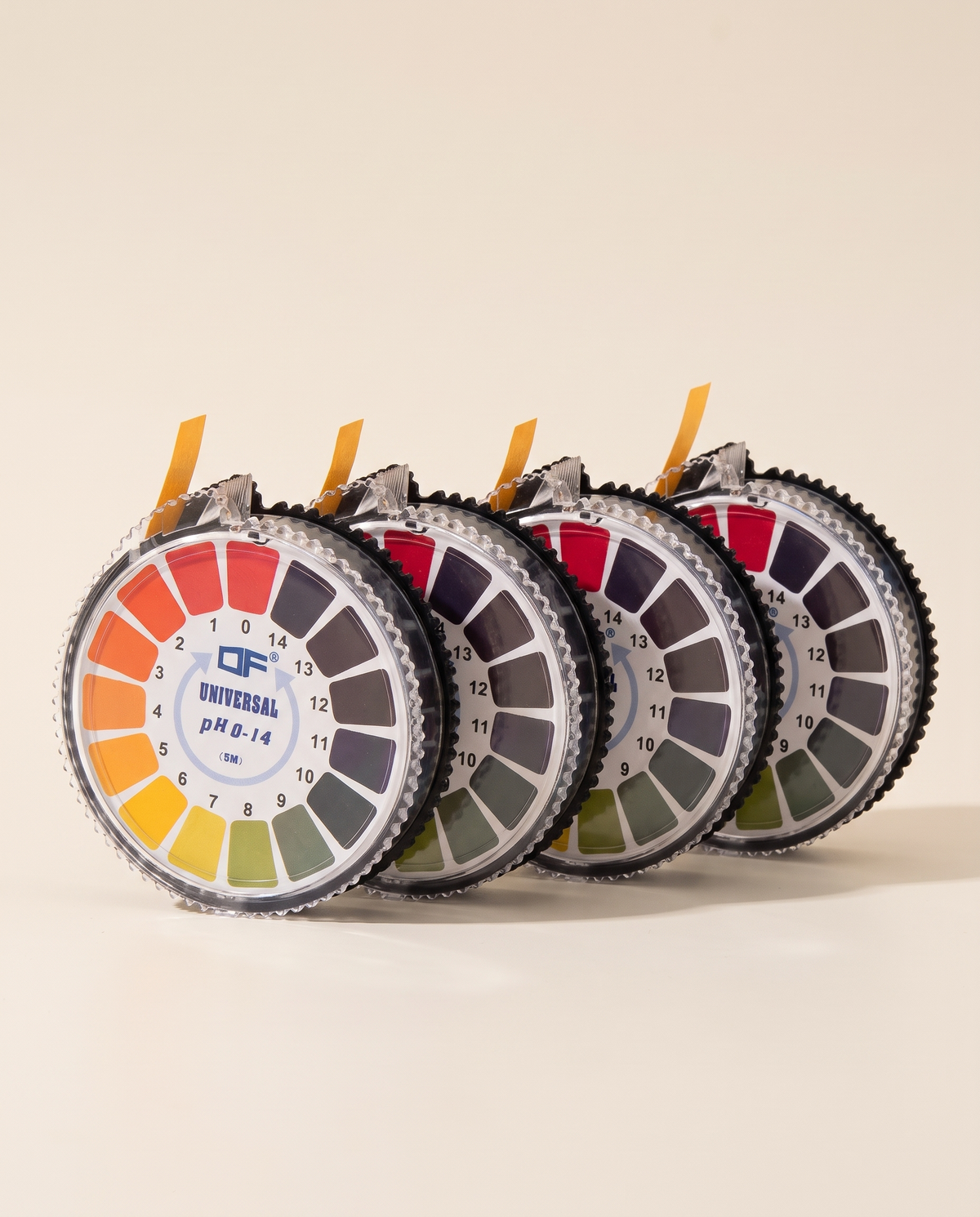 Four pH test paper roll dispensers with printed colour scale