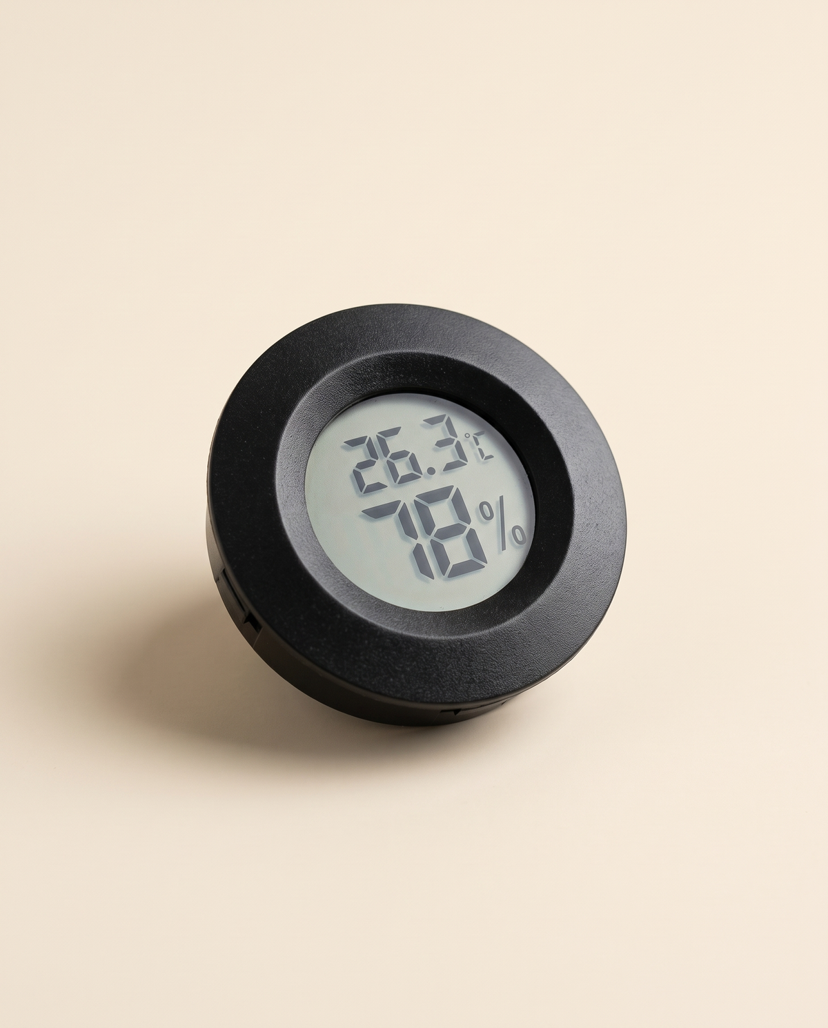Mini round digital thermometer and hygrometer showing Celsius
